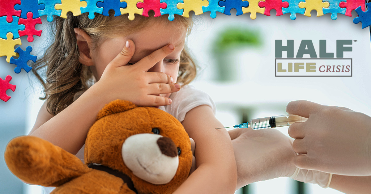 Little girl holding a bear gets vaccination